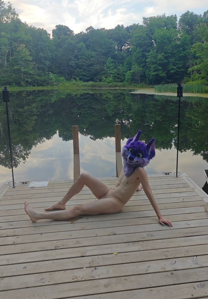 Niqnaq posing on a lake dock, nude