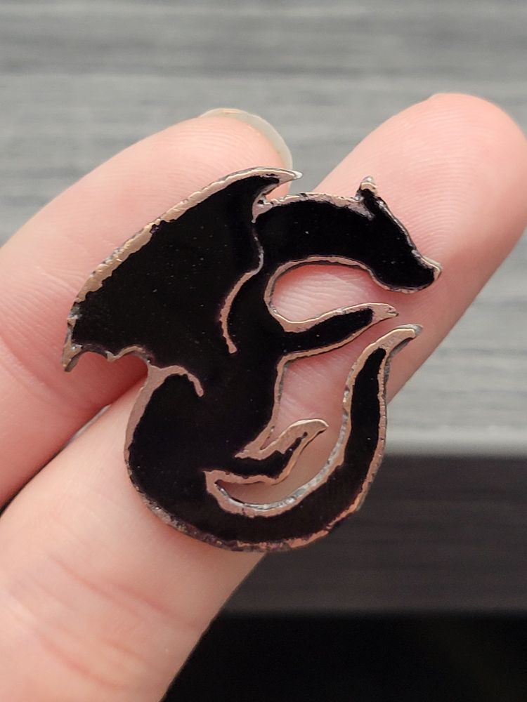 Flat champleve enamel black dragon on copper. All black.
