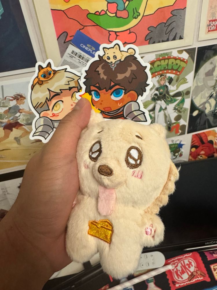 @Eelbeats’ Cheese Dog Kickstarter Plush with matching Laios and Kabru stickers