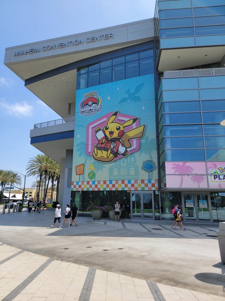 A picture of the Anaheim Convention Center with the Pokémon World Championships 2025 key art plastered on it.