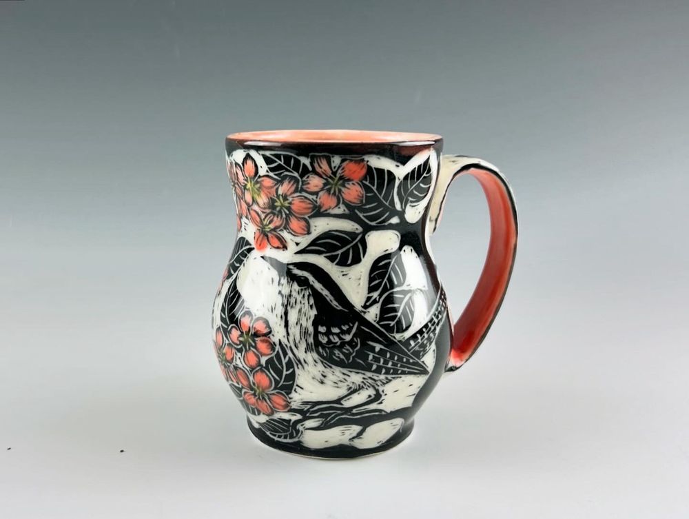 Porcelain sgraffito mug with a pink rum and handle and Carolina Wren in pink plum blossoms.