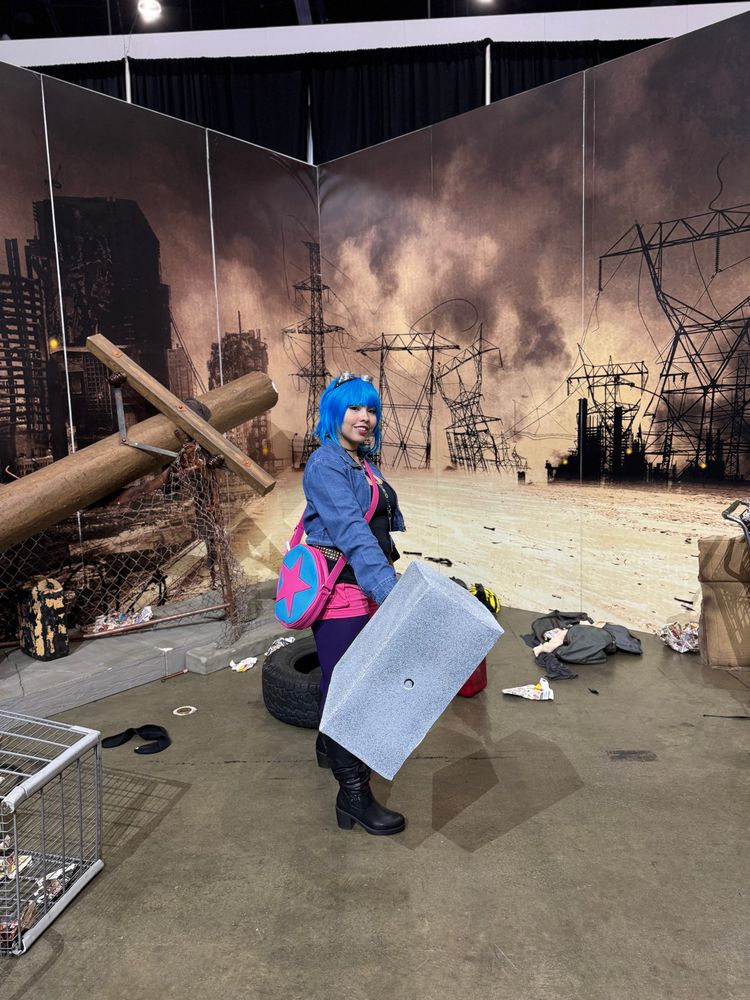 Ramona Flowers from Scott Pilgrim cosplayer in from of a dystopian background.