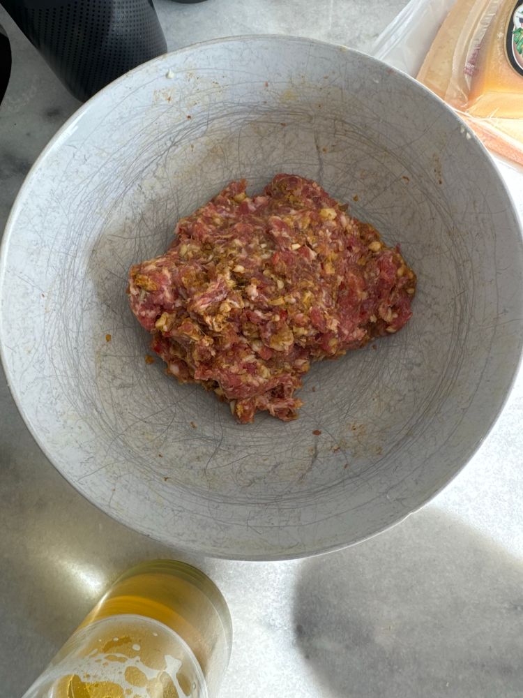 Pork with minced garlic, turmeric, cumin, dried chili flakes, dried thyme, white pepper, paprika, saffron, and a lot of Adoboloco Hamajang smoked ghost pepper hot sauce. 