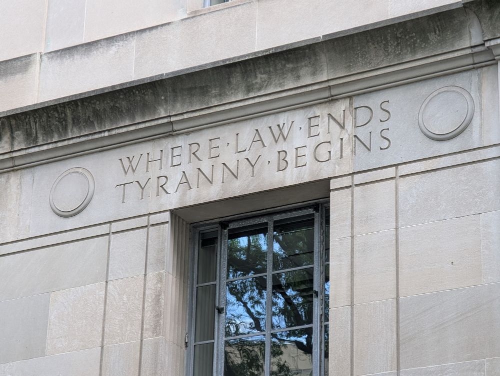 Motto inscribed on the Justice Department headquarters reading "Where Law Ends, Tyranny Begins."
