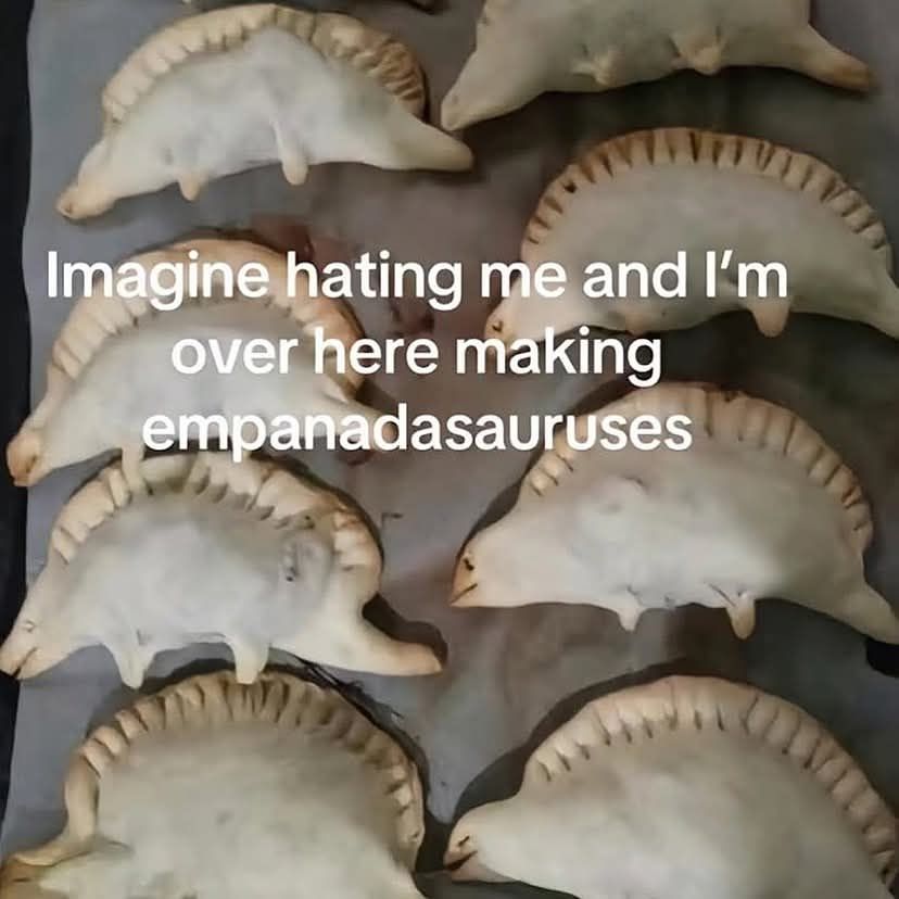 Picture of empanadas shaped like stegosaurus. Text reads imagine hating me and I'm over here making empanadasauruses