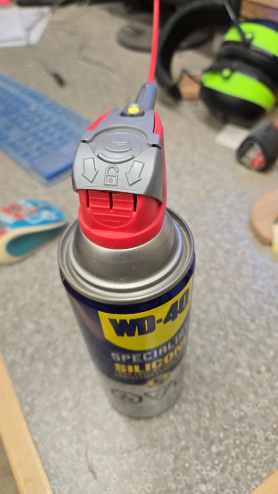 WD-40 can with trigger safety mechanism.