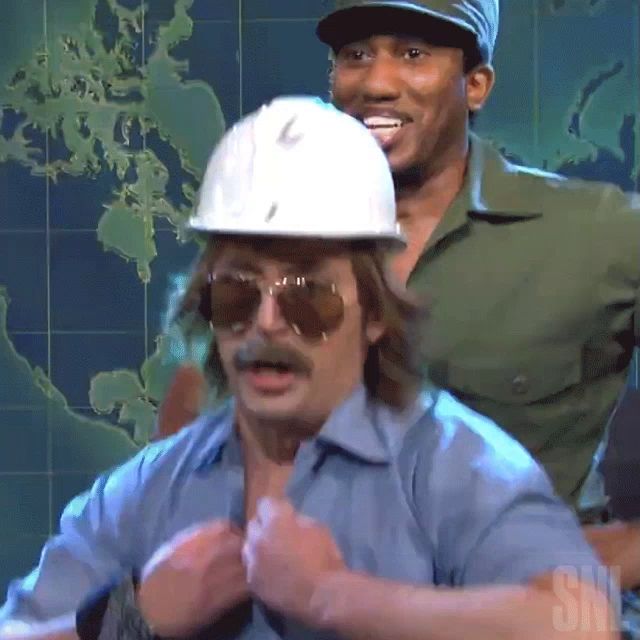 a man wearing a hard hat and sunglasses is standing next to another man