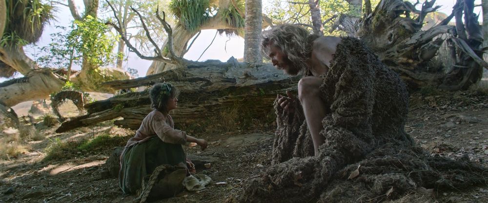 Nori on the left (small) talking to the Stranger on the right (large). The camera is at a slight angle, and showing the size difference between the two.