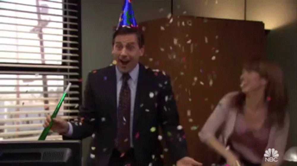 a man wearing a party hat is throwing confetti in the air