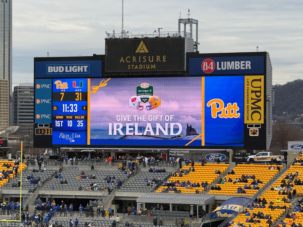 The scoreboard at Heinz Field says “GIVE THE GIFT OF IRELAND” advertising the 2027 kickoff game there against Wisconsin 