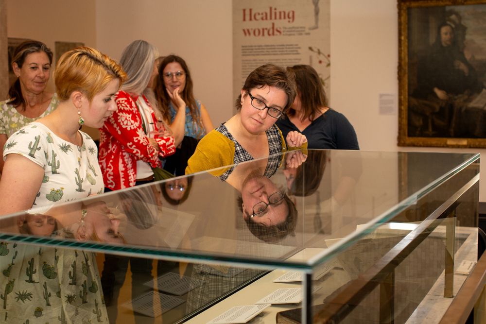 Visitors look into the display cases of an exhibition at the RCP.
