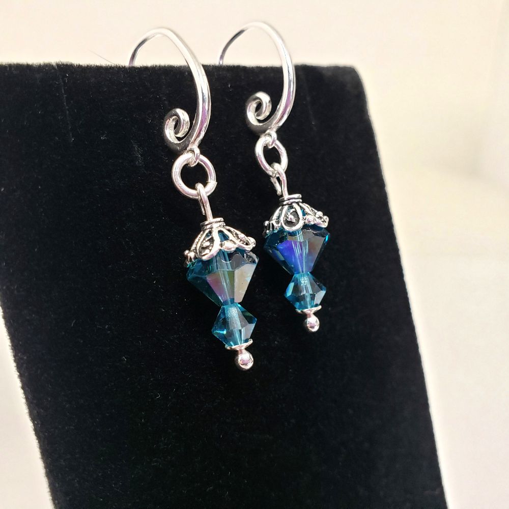 These earrings were inspired by BTS RM/Kim Namjoon solo album INDIGO. Includes 2 each Genuine 8mm and 2 each 4mm Swarovski Bicone Crystal Beads in Indicolite. The 8mm beads have an Aurora Borealis affect for extra sparkle. All silver components are .925 Sterling Silver.