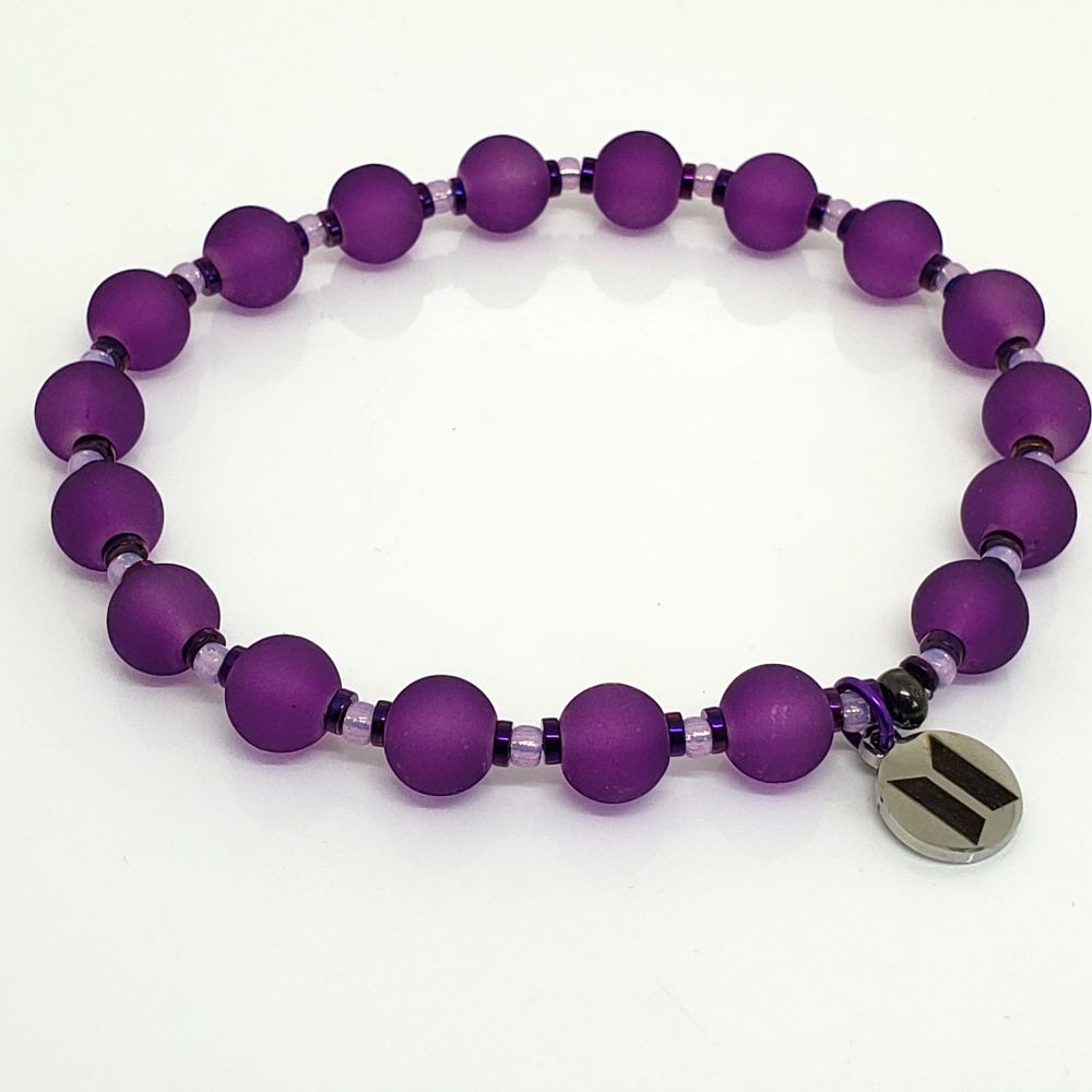 Size 8.0” BTS ARMY inspired Bracelet with a stainless steel charm with BTS logo on one side and ARMY logo on the other side. Includes 8mm Frosted glass beads in Purple, purple hematite rondelle beads, and 8/0 Miyuki dyed lilac silver lined alabaster seed beads. Crimp bead is gun metal plated brass which hides/protects the knot. Please tell me your bias so I can include a surprise!