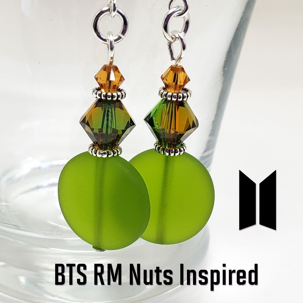 These earrings were inspired by BTS RM's sweater in his MV for Nuts. Includes 2 each 8mm Swarovski Bicone Crystal Beads that are a blend of Dark Moss and Topaz, 2 each 4mm Swarovski Topaz Bicone beads and 2 each man-made Sea Glass beads. Spacer beads and All silver components are .925 Sterling Silver.
