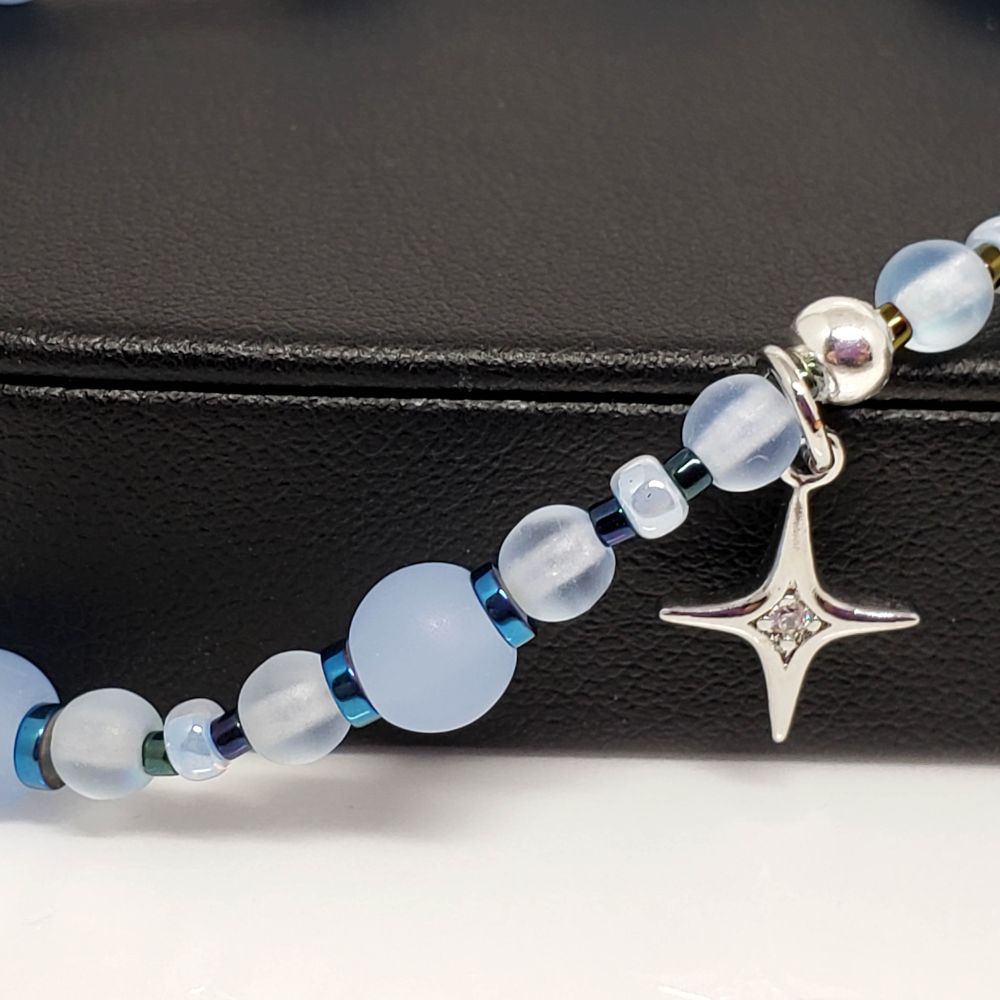 Czech bead TXT inspired stretch bracelet with sterling silver charm. Size 7.5-7.75"
