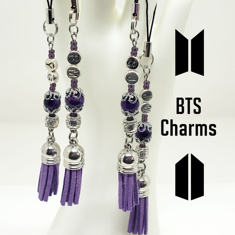 BTS member inspired clip on charms. Beads include: 8mm Round Tiger Eye beads, 8/0 Japanese seed beads and alloy spacer beads. The Letter beads are 6mm Zinc alloy metal. The lanyard has a split ring made of premium iron, aluminum and a black polyester string that is strong but flexible. Finished with a 35mm Purple Faux Suede Tassel with Silver Plastic End Cap. Other findings are stainless steel. Measures approximately 5.5" long.