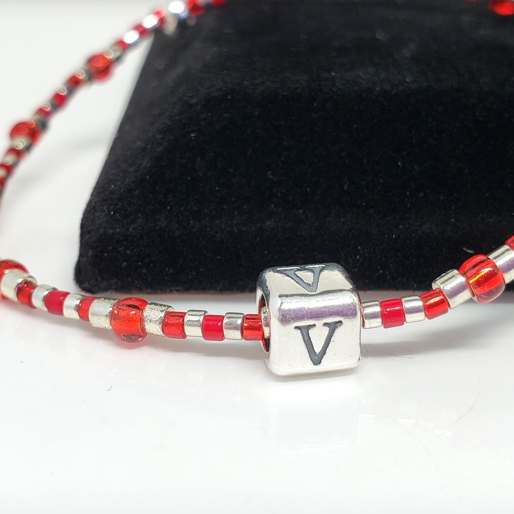 Size 6.25" bracelet inspired by BTS member V's red mic. Includes Japanese seed beads: Silverlined red beads and galvanized silver. The slide bead is a 6mm .925 Sterling Silver square bead with the letter V on all 4 sides. The crimp bead is sterling silver and hides/protects the knot. I am an ARMY and all my bracelets are handmade by me.