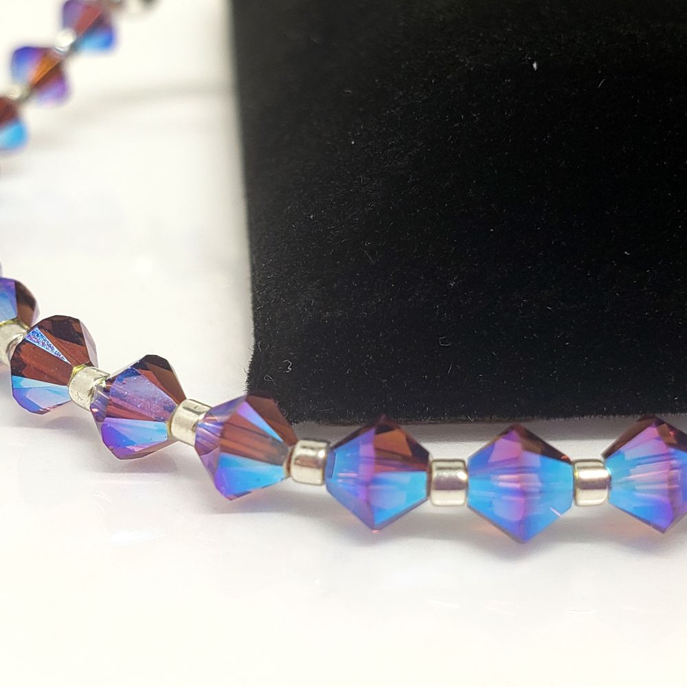 Close up of Amethyst Swarovski bead with the Aurora Borealis affect