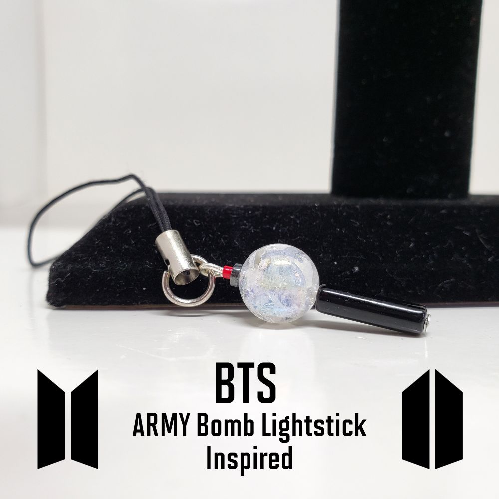 BTS ARMY lightstick Bomb Charm with cell phone strap. Main bead is 10mm Crystal Quartz Gemstone AAA Quality. Lightstick handle is black onyx bead with a hematite rondelle and a red seed bead for the fuse on the bomb.