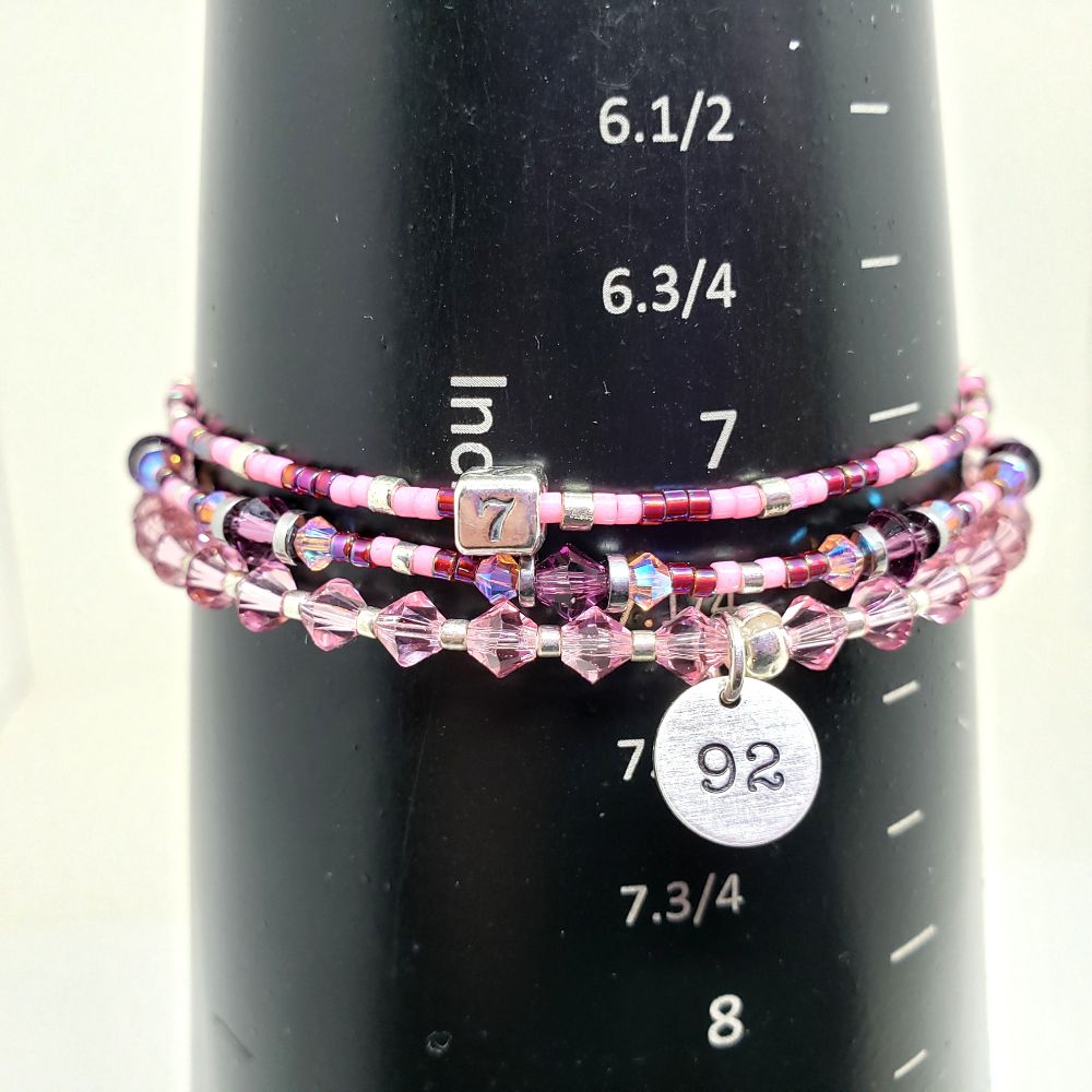 Size 7.25" BTS Jin / Seokjin Pink Microphone, 92-liner and 7 Inspired Bracelet Set. Includes 4mm Genuine Bicone Swarovski Crystals in Light Rose and Amethyst, 3mm Genuine Bicone Swarovski Crystals in Light Rose AB2X (aurora borealis), hematite spacer beads, seed beads in galvanized silver, opaque carnation pink-dyed white, and opaque silver-lined rainbow dark cranberry. Main bracelet includes a custom Sterling Silver 92 charm for his birthyear and seed bead bracelet includes a sterling silver 7 bead. Jumprings and crimp beads are also sterling silver. Crimp beads hide/protect the knots. My bracelets are all hand-made and I am an ARMY.