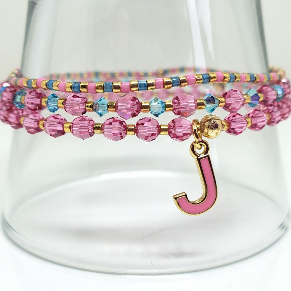 Size 7.0" BTS Jin ECHO album inspired bracelet set. Includes Genuine Swarovski Crystal beads: 4mm round beads in Rose and 3mm bicone beads in Indicolite. Japanese seed beads are galvanized gold, translucent light blue lined rainbow crystal clear and opaque carnation pink dyed white. The letter J charm is 14K gold filled and enamel. Crimp beads are gold filled and hide/protect the knots. All bracelets finished with a gold filled crimp bead to protect and hide the knot. My bracelets are all hand-made and I am an ARMY.
