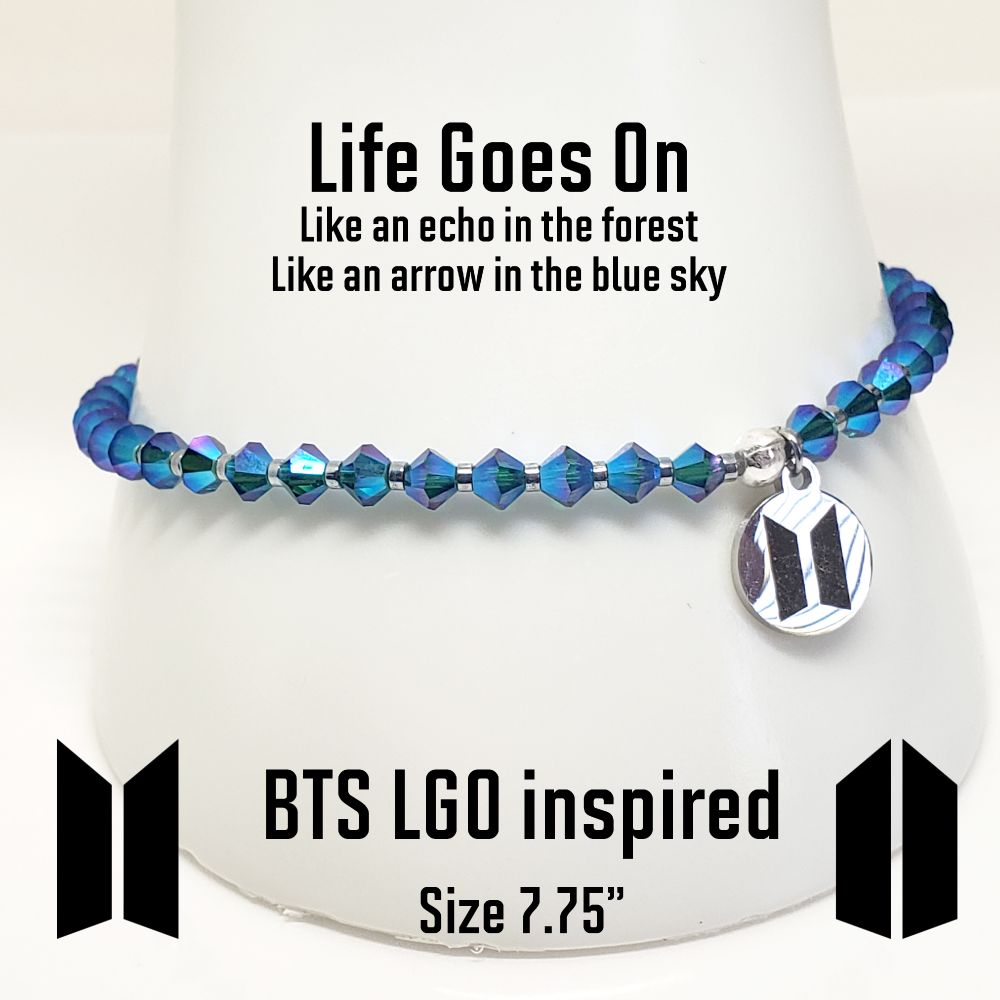 Size 7.75" BTS Life Goes On inspired stretch bracelet. Includes Genuine Swarovski Crystal beads in Emerald AB (Aurora Borealist affect on entire bead) and hematite rondelle spacer beads. The charm is a stainless steel laser engraved disk with BTS logo on one side and ARMY logo on the other side. Finished with a sterling silver crimp bead to hide and protect the knot. My bracelets are all hand-made and I am an ARMY.