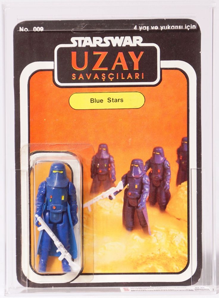 Photo of an “Uzay” bootleg Star Wars figure on sealed cardback. Figure is a blue repaint of a snowtrooper with a white blaster rifle, and card art is an awesome photos of multiple blue snowtroopers against a gold and orange backdrop of rock perhaps lava-like terrain. Character on card is “Blue Stars”, card is formatted like vintage SW action figure packaging from the era 