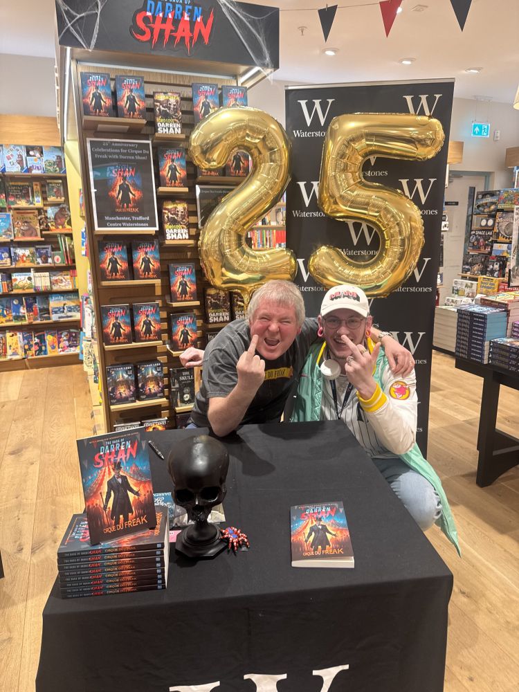 Darren Shan and my friend, giving the middle finger to the camera.
