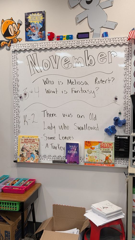 School dry erase board in a library that shows for the month of November that 3rd and 4th graders are reading Sue B and the Ridders (my book)