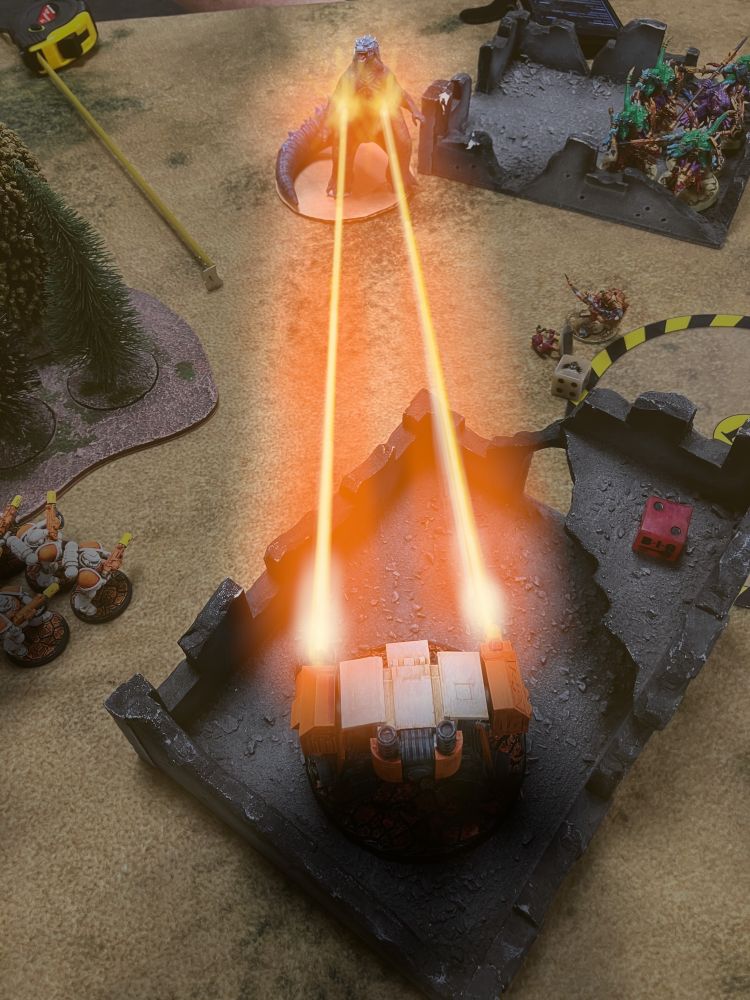 The Attack Walker fires its two fusion cannons at the giant lizard.