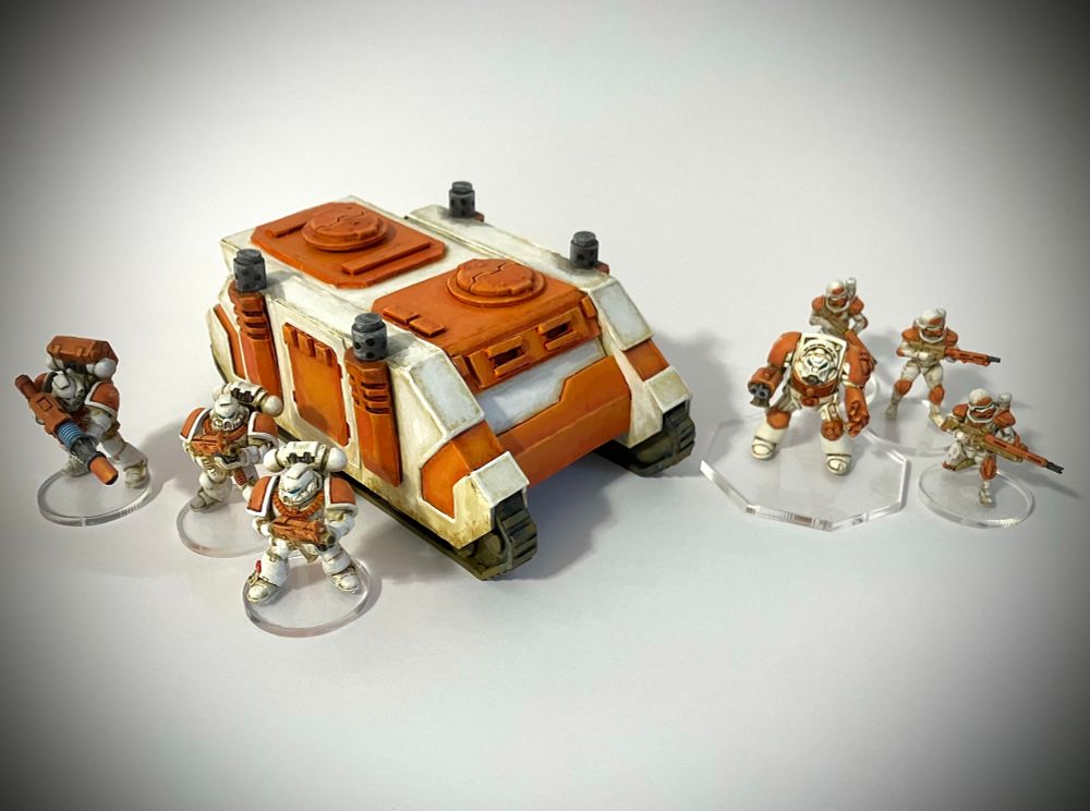 Space Marines on clear acrylic bases. Acrylic bases blend with any terrain board and requires no painting. But I found they are hard to stick models onto since superglue is the only option and it can cloud the clear base.
