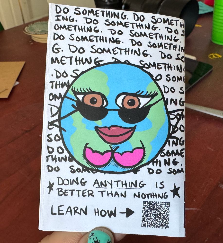 Mother earth looks at you over her sunglasses over the words "Do something" repeated a bunch of times, then under her it says "Doing anything is better than nothing", "learn how" and a qr