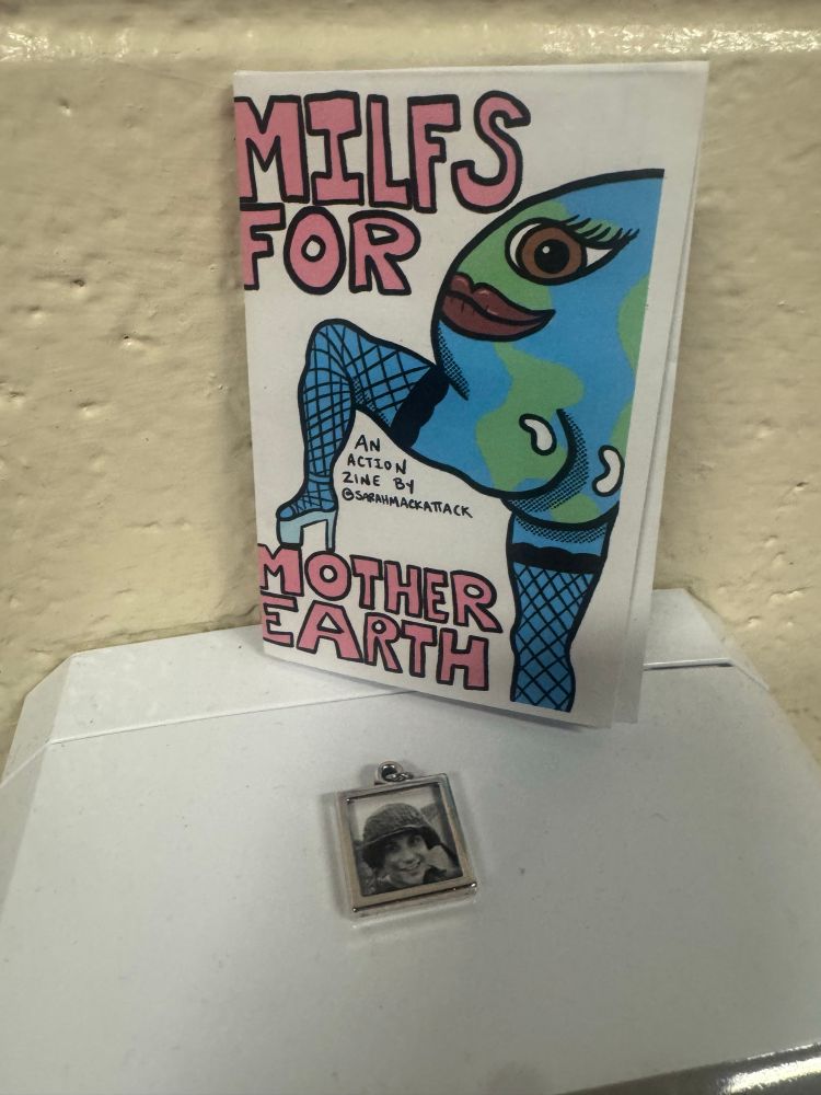 A zine with a hot Mother Earth with fishnets with one leg up on the words MILFS for Mother Earth