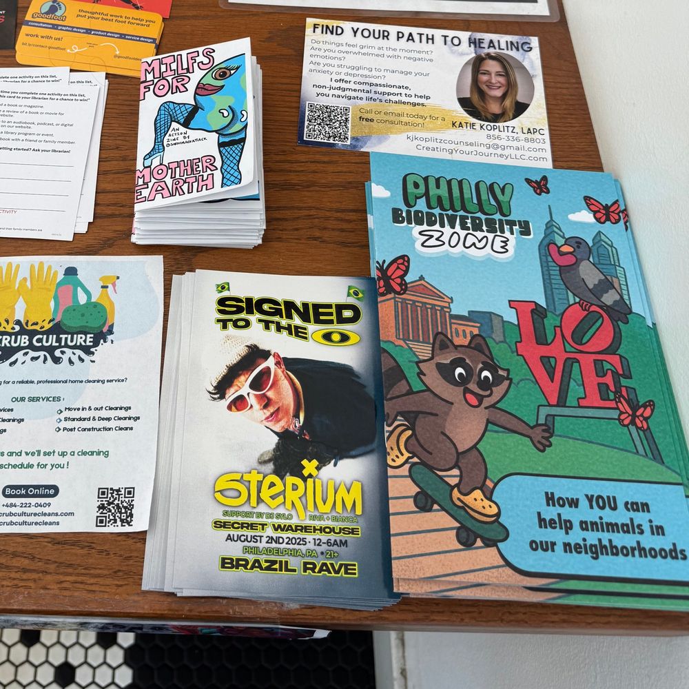 That pile of stuff at a coffee shop with both a stack of the Skype a scientist “Philly biodiversity zine” and Sarah’s psychotic “milfs for Mother Earth” zine with a caked up Mother Earth with thigh high fishnets, looking back at it 