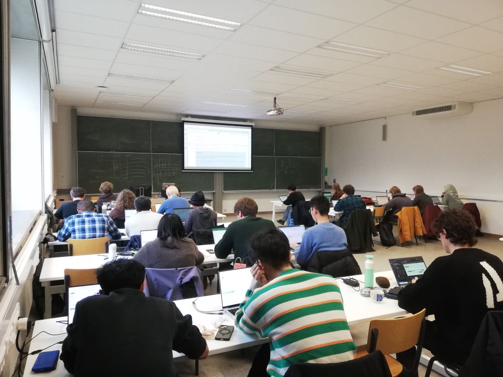 Computer room with participants working on code exercises in xarray.