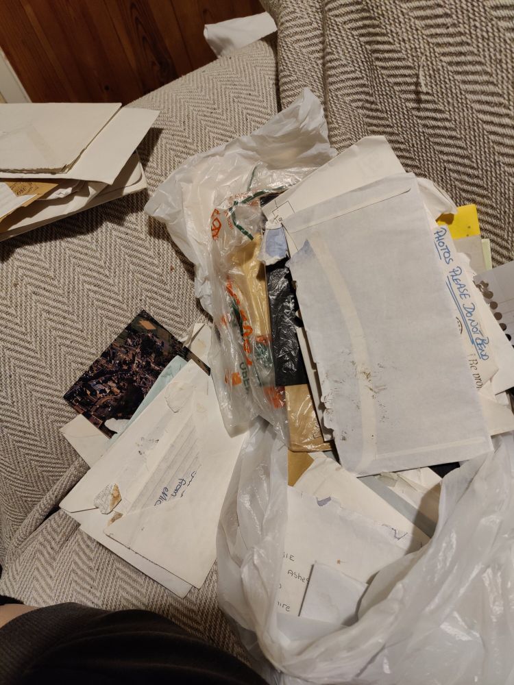 A big bag of envelopes on a settee 
