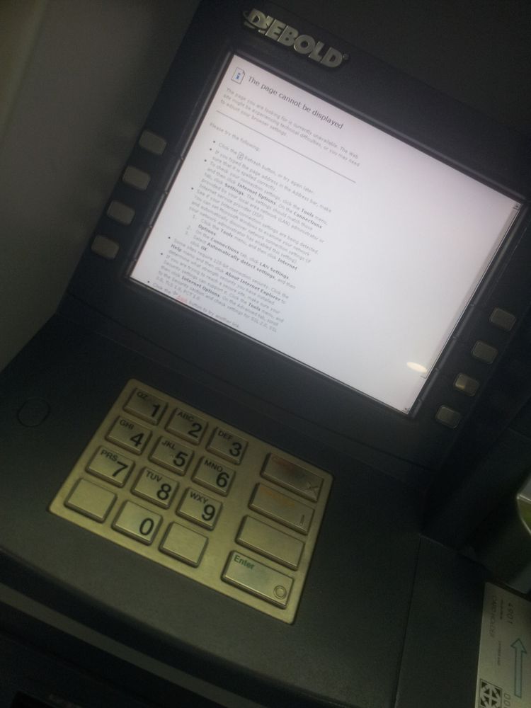 A cash teller machine, but the screen is just displaying an Internet Explorer era error message.