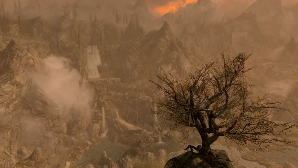 Valleys and waterfalls of Skyrim with tree in foreground