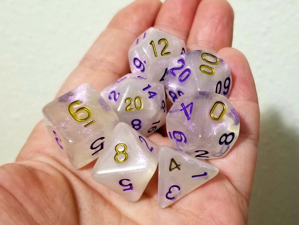 Generic shimmer polyhedral dice with purple ink, with the 'crit' faces hand-inked in gold.