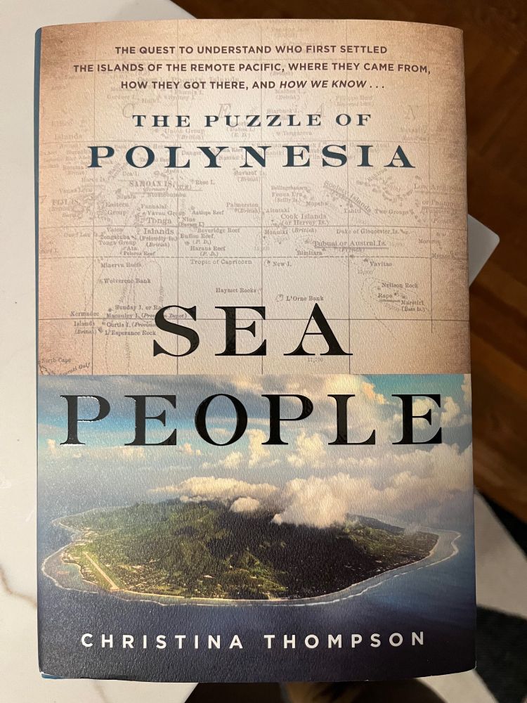 The cover of a hardback book titled Sea People. The author is Christina Thompson. There is a teaser for the topic at the top of the book, which reads “the quest to understand who first settled the islands of the remote Pacific, where they came from, how they got there, and how we know… The Puzzle of Polynesia”. The implication of the design is that “the Puzzle of Polynesia” is the subtitle of the book. The background image on the cover is split. It features a sepia-toned hand-written map for the top half, and an aerial view through a partly cloudy sky to a green island in deep blue water for the lower half.