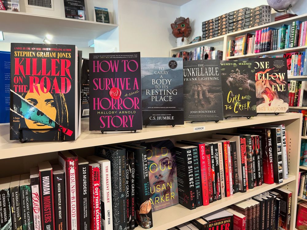Horror section with new releases killer on the road by Stephen Graham Jones how to survive a horror story by Mallory Arnold to carry a body to its resting place by cs humble the Unkillable Frank lightening by Josh rountree girl in the creek by Wendy n Wagner and one yellow eye by Leigh Radford