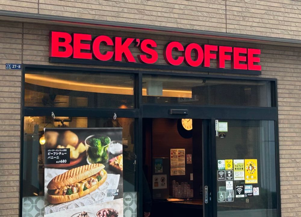 A coffee shop called BECK’S COFFEE. Sign is in red sans serif lit up.