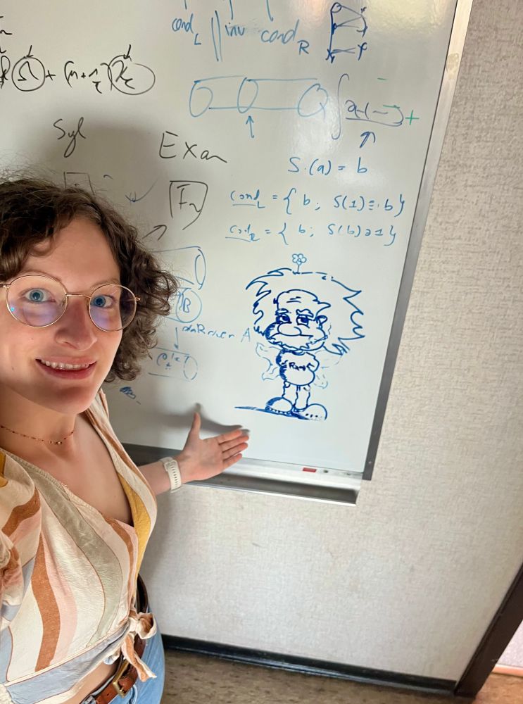 Emilie at the whiteboard showing a drawing of Einstein