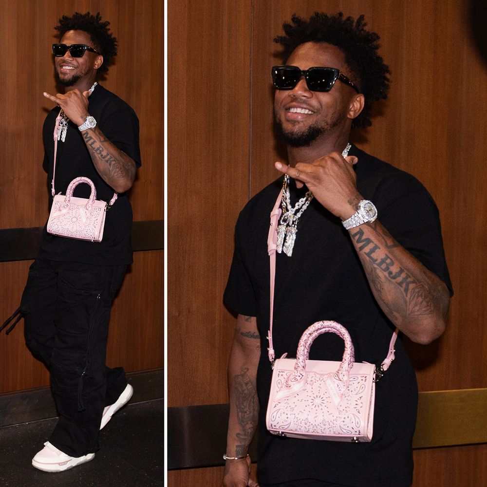 Two photos of Ronald Acuña Jr. walking into Truist Park. He's wearing a black shirt and black pants with multiple diamond necklaces, a pink handbag and pink shoes.