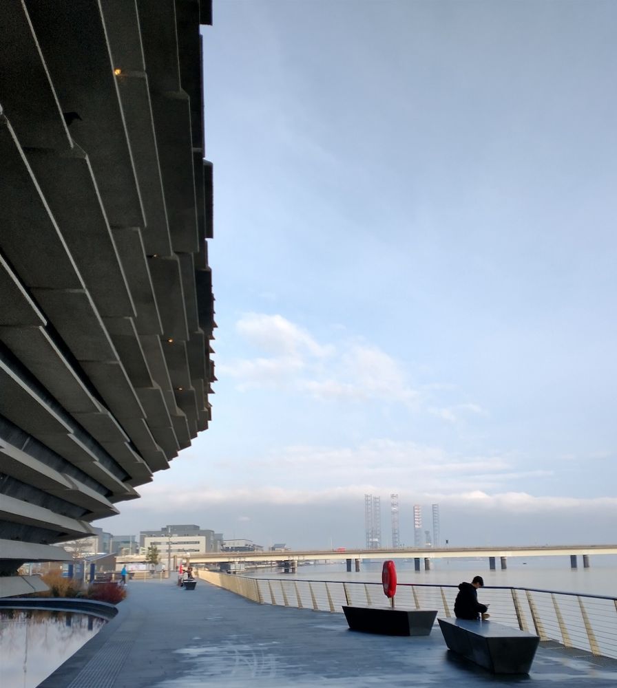 The Tay walkway, a side of the V&A Museum, and the Tay road bridge in hazy conditions.