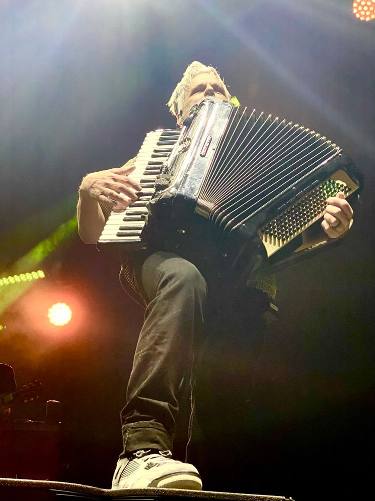 Low-angle shot of Charlie Gillingham of Counting Crows playing accordion during “Omaha”