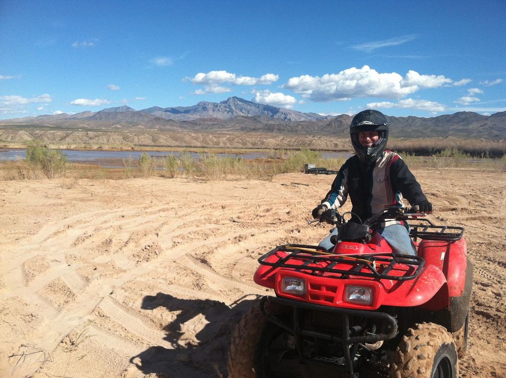 Surveyor leaves parking area by the Virgin River on ATV to access survey plot.