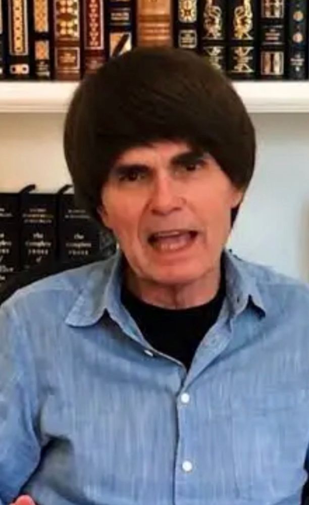 A spaceballs esque hair helmet sat atop the head of famous novelist dean koontz. 