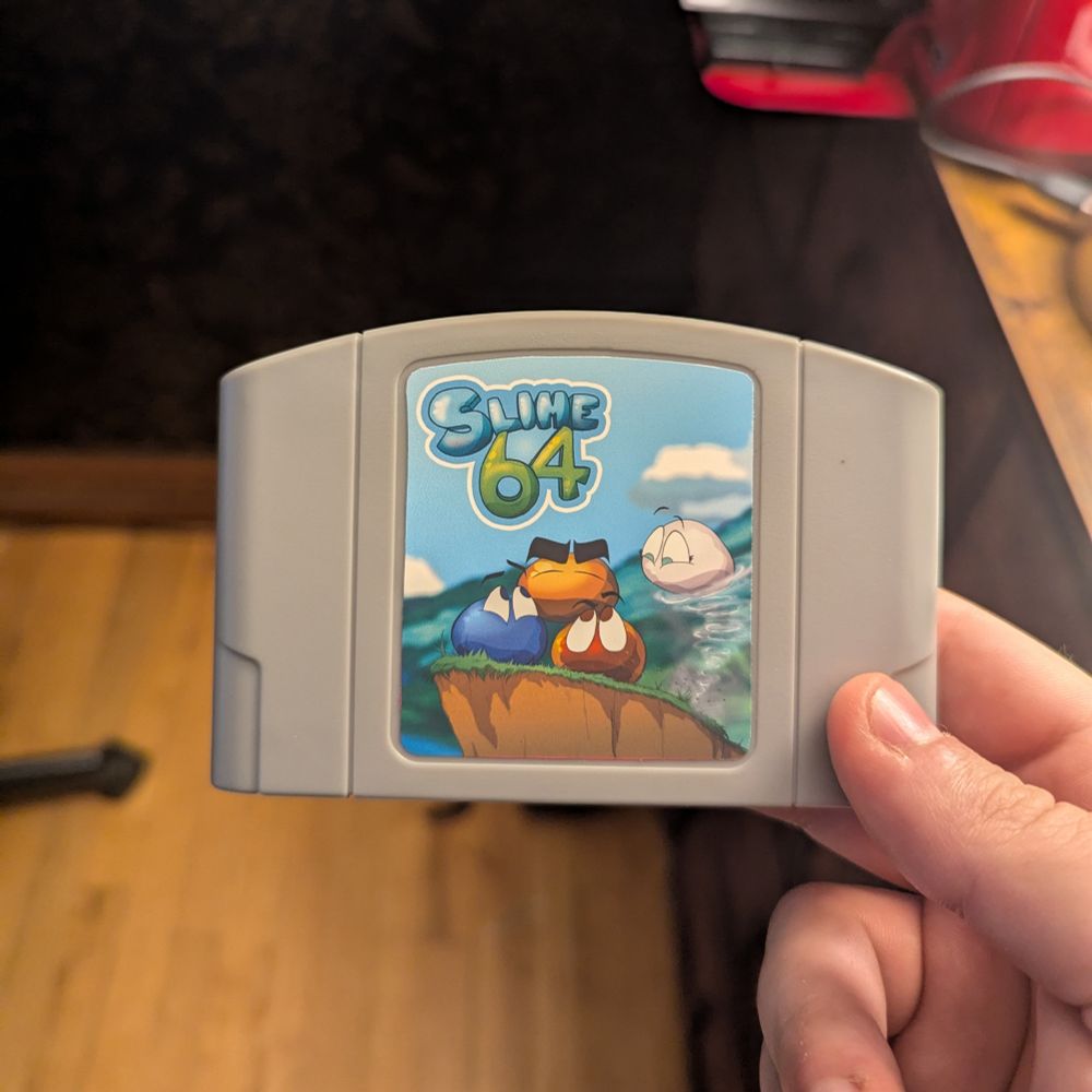 A gray N64 cartridge with a Slime 64 label