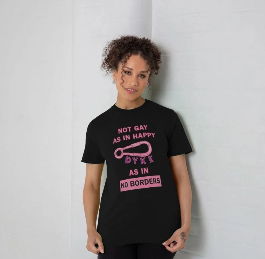 Pink Text on Black T-shirt reads: Not Gay as In Happy Dyke As In No Borders